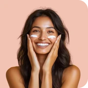 Woman smiling with a radiant, glowing face showing healthy and refreshed skin after skincare treatment.